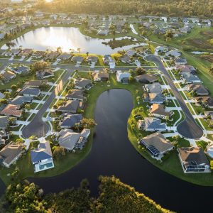 Waterfront single family homes in Florida residential area at sunset. Real estate development in American suburbs.